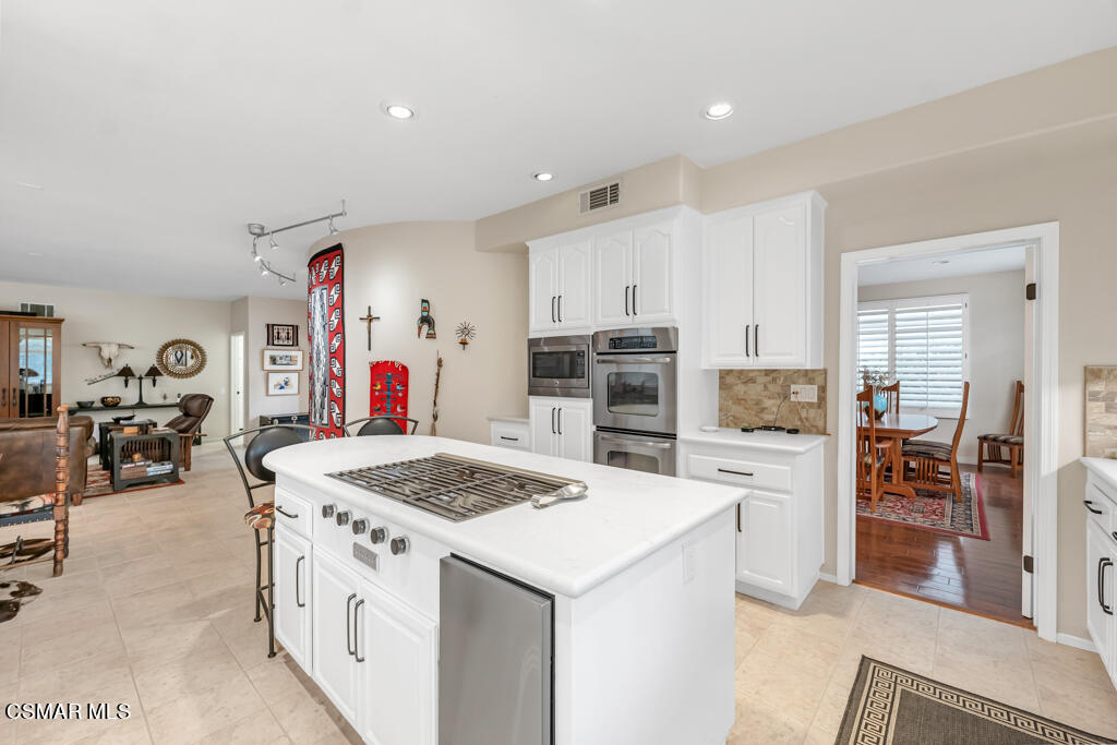4372 Clearwood Road Moorpark, CA 93021 - Photo 23 of 51 a kitchen that has a lot of cabinets a sink and appliances