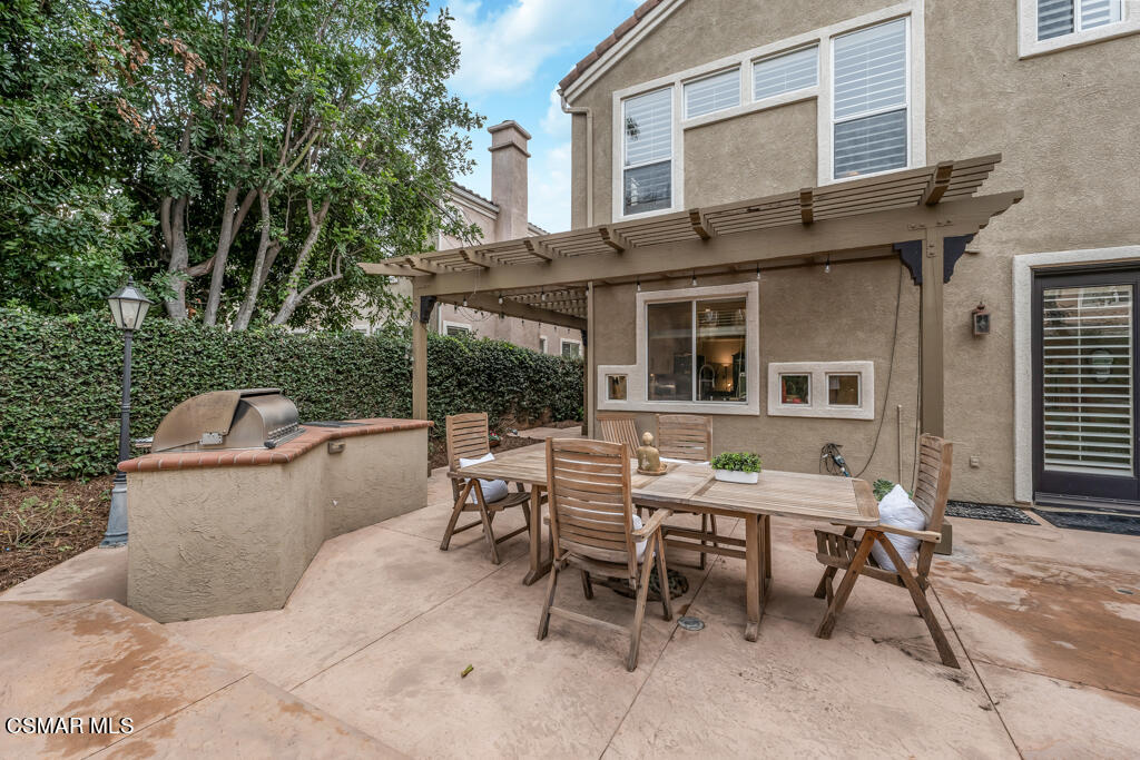 4372 Clearwood Road Moorpark, CA 93021 - Photo 46 of 51 a view of a patio with table and chairs and wooden fence