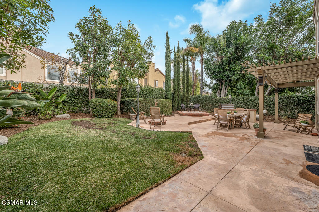 4372 Clearwood Road Moorpark, CA 93021 - Photo 49 of 51 a view of a patio with a table and chairs under an umbrella