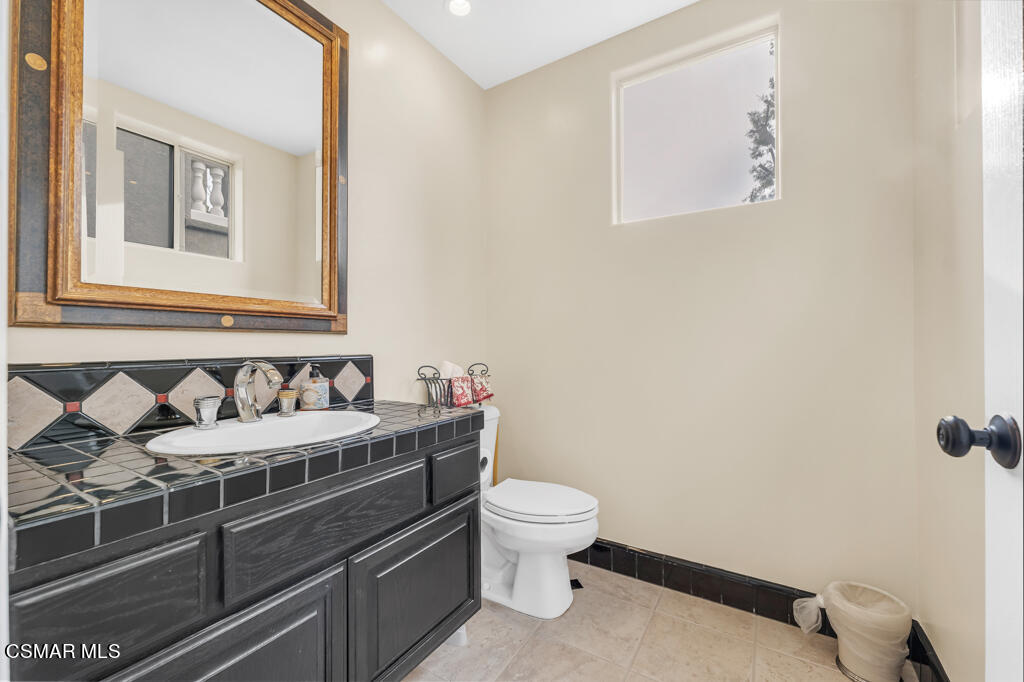 4372 Clearwood Road Moorpark, CA 93021 - Photo 5 of 51 a bathroom with a granite countertop toilet sink and mirror