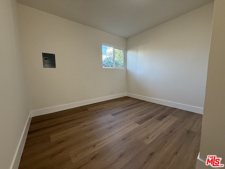 1716 Locust Avenue, Unit 4 Long Beach, CA 90813 - Photo 5 of 11 a view of an empty room with wooden floor and a window