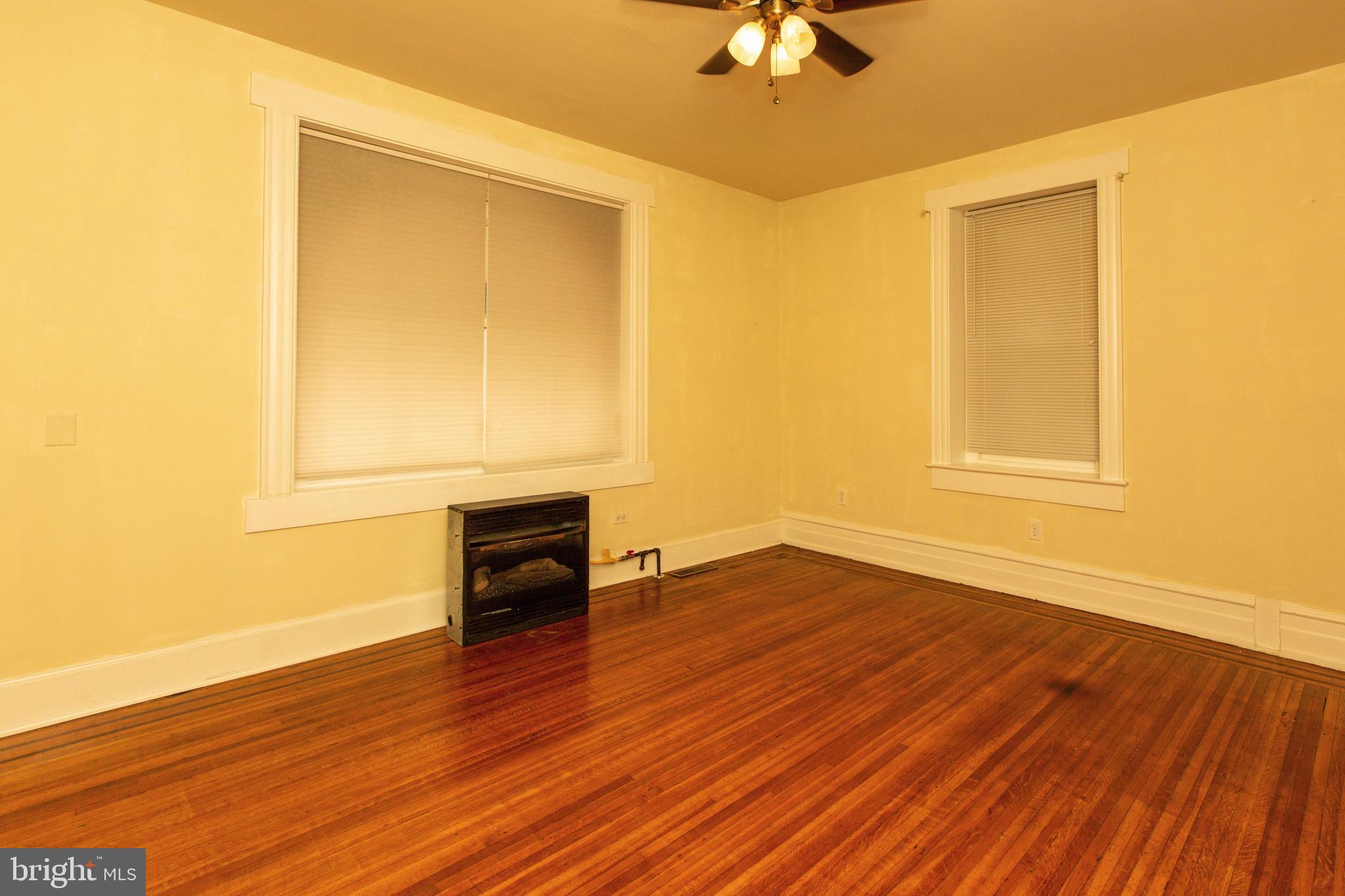 334-1-f East Main Street, Unit 1F Collegeville, PA 19426 - Photo 3 of 10 a view of empty room with wooden floor and fan