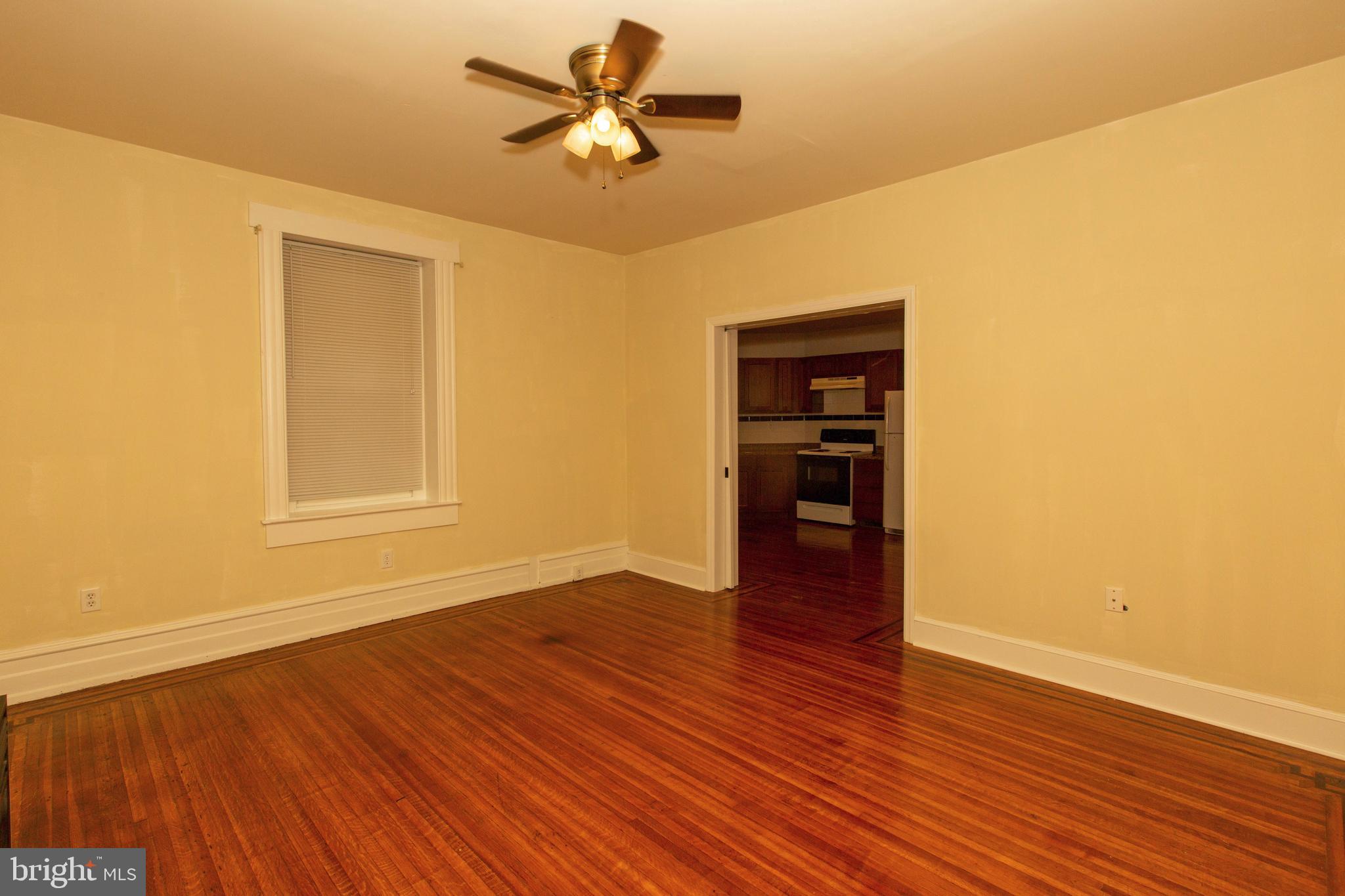 334-1-f East Main Street, Unit 1F Collegeville, PA 19426 - Photo 4 of 10 a view of empty room with wooden floor and fan