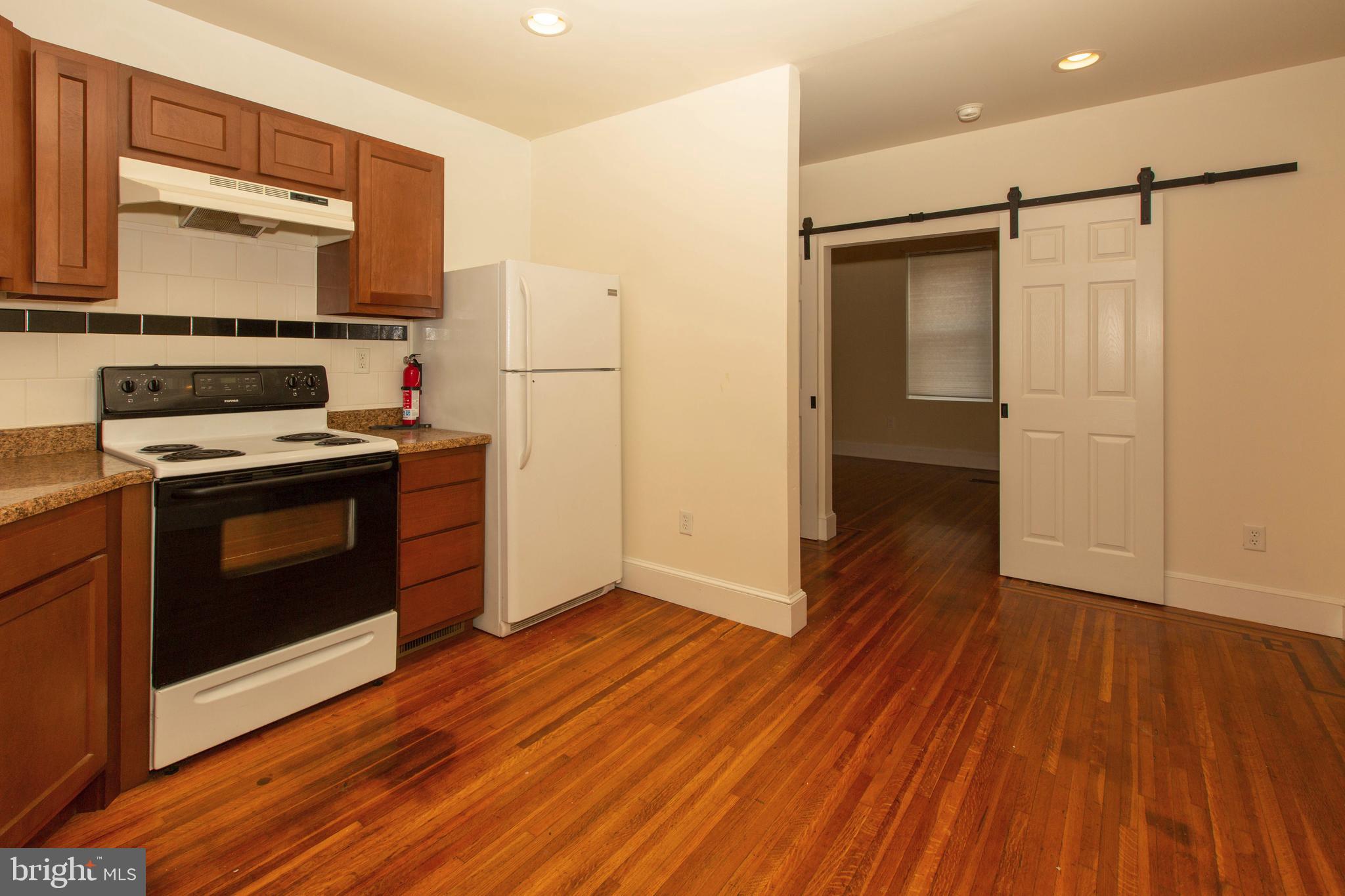 334-1-f East Main Street, Unit 1F Collegeville, PA 19426 - Photo 6 of 10 a kitchen with wooden floors and a stove