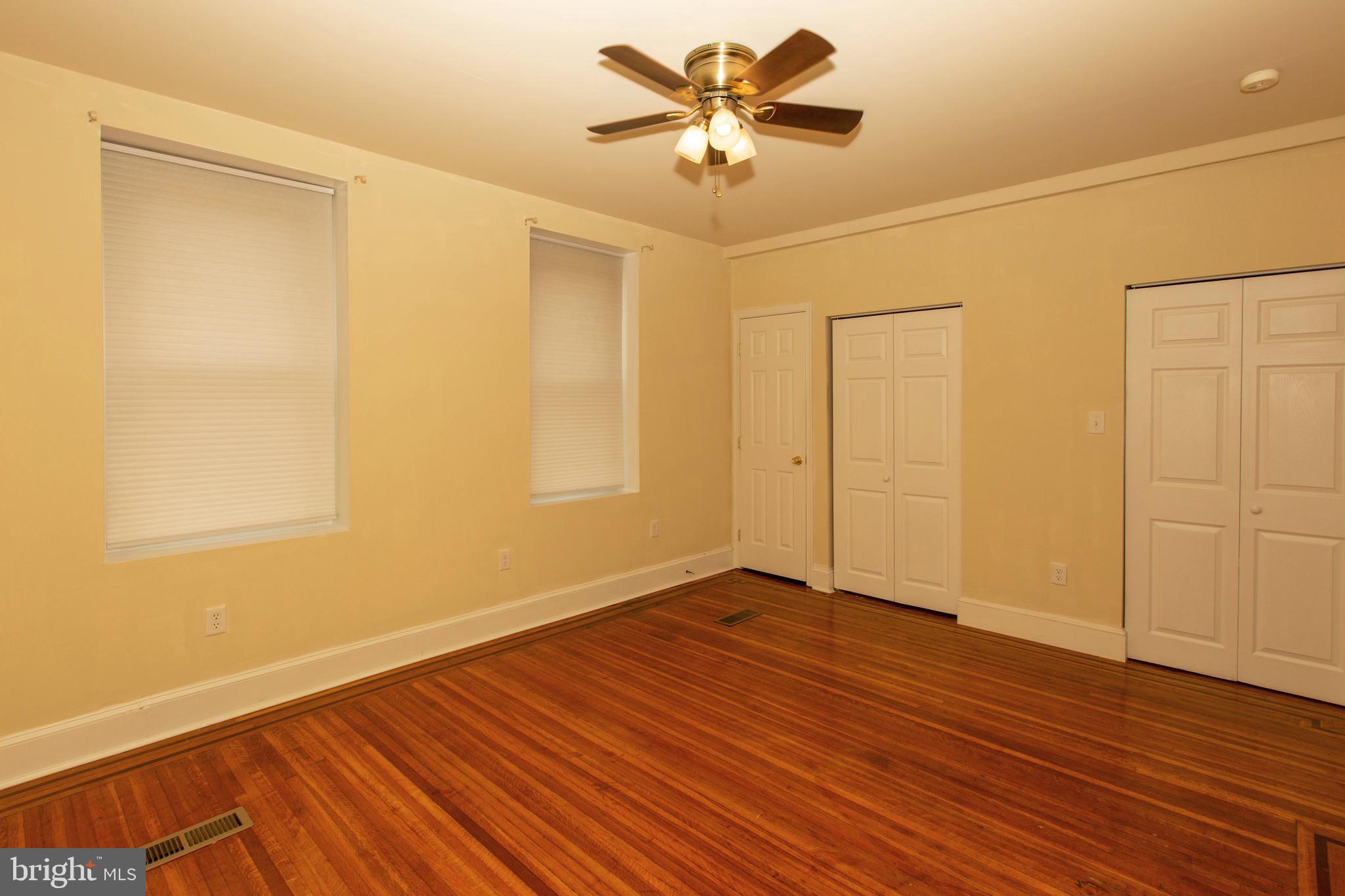 334-1-f East Main Street, Unit 1F Collegeville, PA 19426 - Photo 8 of 10 a view of an empty room with wooden floor and a ceiling fan