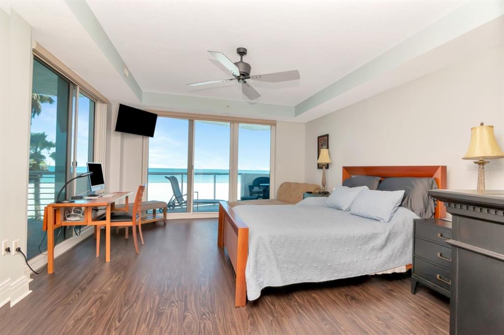 1350 Gulf Boulevard, Unit 301 Clearwater Beach, FL 33767 - Photo 18 of 75 a bedroom with a bed and wooden floor