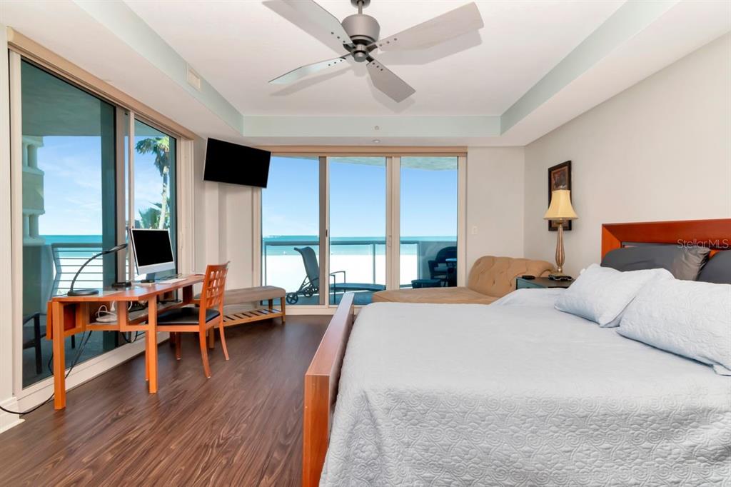 1350 Gulf Boulevard, Unit 301 Clearwater Beach, FL 33767 - Photo 19 of 75 a bedroom with furniture and large windows