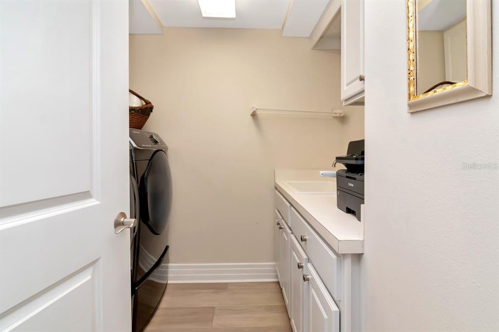 1350 Gulf Boulevard, Unit 301 Clearwater Beach, FL 33767 - Photo 23 of 75 a kitchen with a refrigerator and a stove