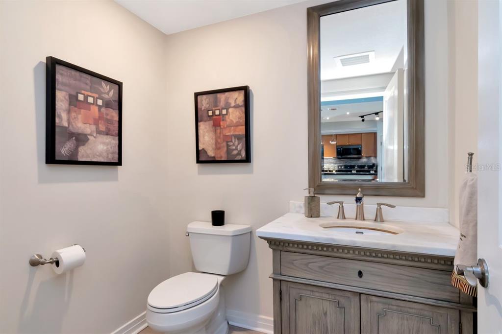 1350 Gulf Boulevard, Unit 301 Clearwater Beach, FL 33767 - Photo 27 of 75 a bathroom with a toilet a sink and mirror
