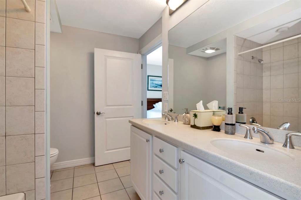 1350 Gulf Boulevard, Unit 301 Clearwater Beach, FL 33767 - Photo 28 of 75 a bathroom with a sink and a mirror