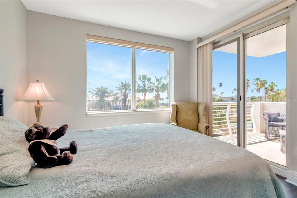 1350 Gulf Boulevard, Unit 301 Clearwater Beach, FL 33767 - Photo 29 of 75 a spacious bedroom with a large bed and a window