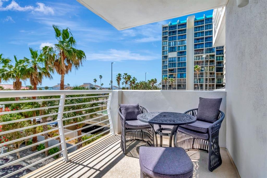 1350 Gulf Boulevard, Unit 301 Clearwater Beach, FL 33767 - Photo 34 of 75 a view of a chairs and table on the terrace