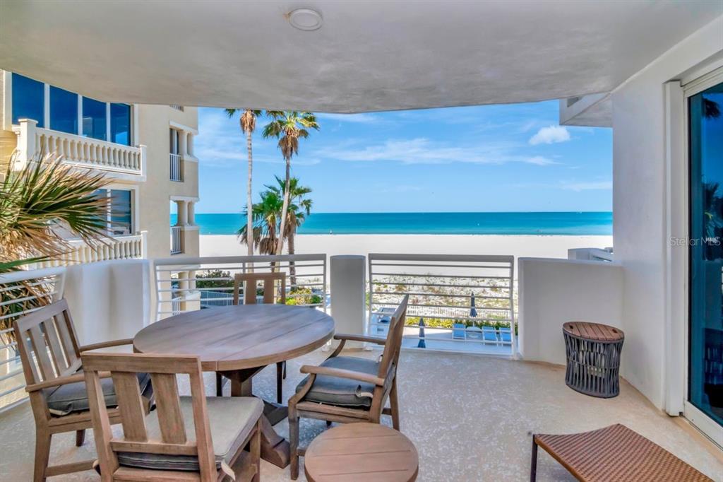 1350 Gulf Boulevard, Unit 301 Clearwater Beach, FL 33767 - Photo 35 of 75 a dining room with furniture and a floor to ceiling window