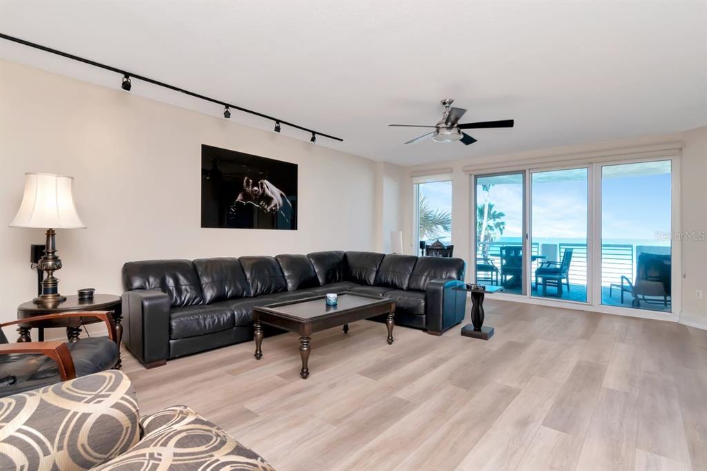 1350 Gulf Boulevard, Unit 301 Clearwater Beach, FL 33767 - Photo 5 of 75 a living room with furniture ceiling fan and a window