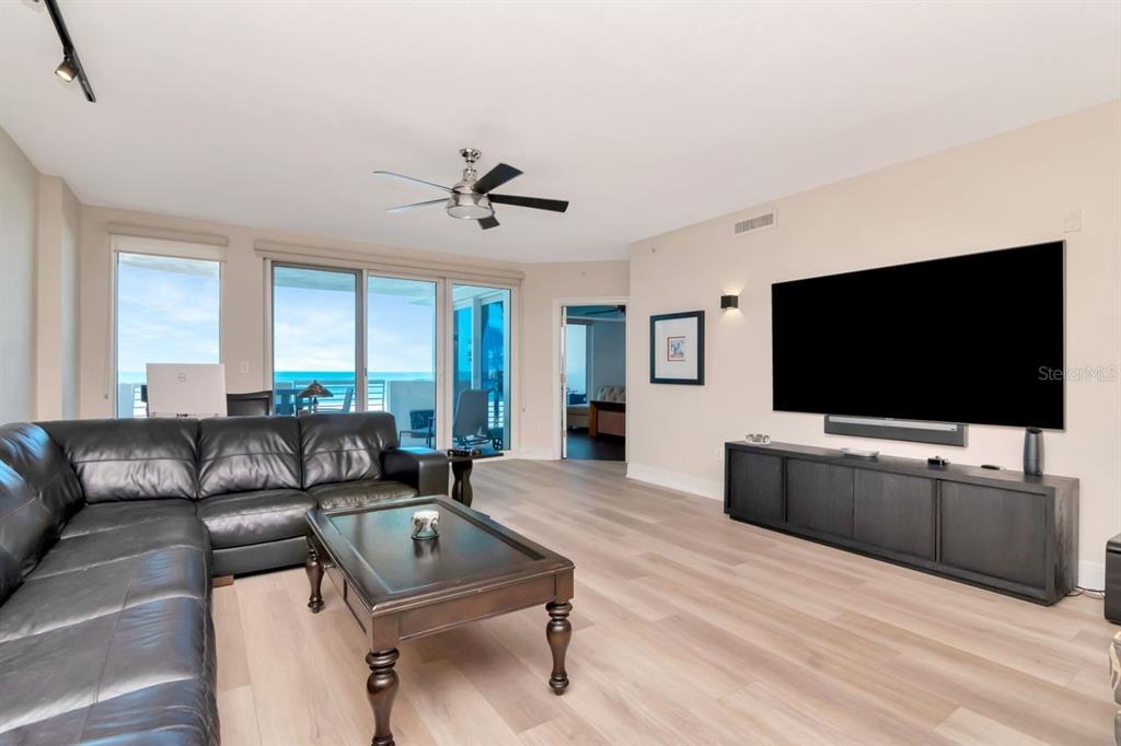 1350 Gulf Boulevard, Unit 301 Clearwater Beach, FL 33767 - Photo 6 of 75 a living room with furniture and a flat screen tv
