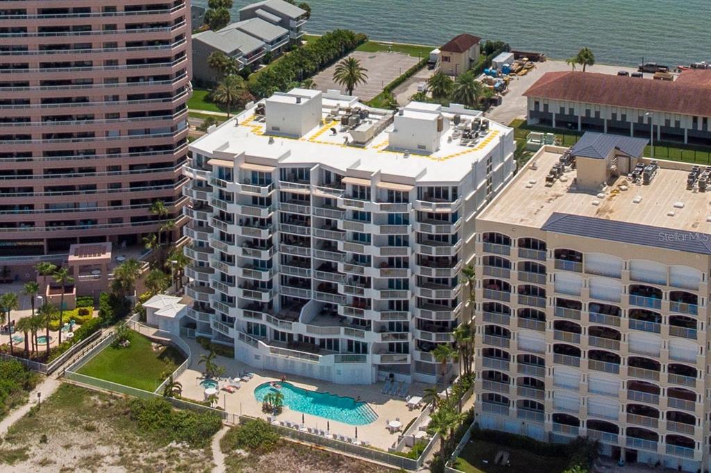 1350 Gulf Boulevard, Unit 301 Clearwater Beach, FL 33767 - Photo 64 of 75 a view of a patio with table and chairs potted plants