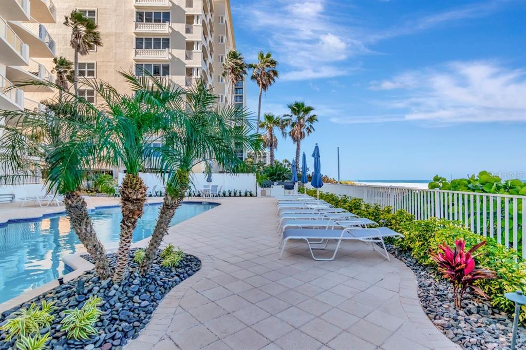 1350 Gulf Boulevard, Unit 301 Clearwater Beach, FL 33767 - Photo 70 of 75 a view of a patio with plants and table and chairs