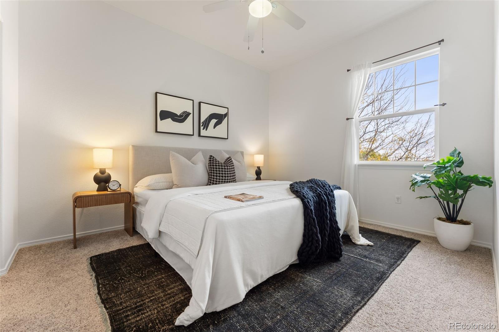 8420 Canyon Rim Trail, Unit 305 Parker, CO 80134 - Photo 11 of 44 a bedroom with a bed and a potted plant