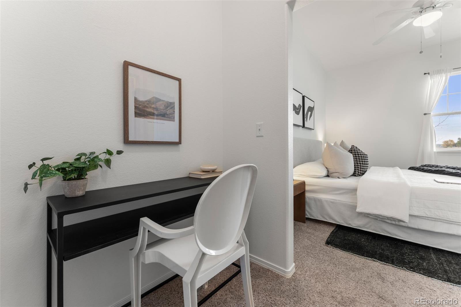 8420 Canyon Rim Trail, Unit 305 Parker, CO 80134 - Photo 12 of 44 a bedroom with a bed and a potted plant