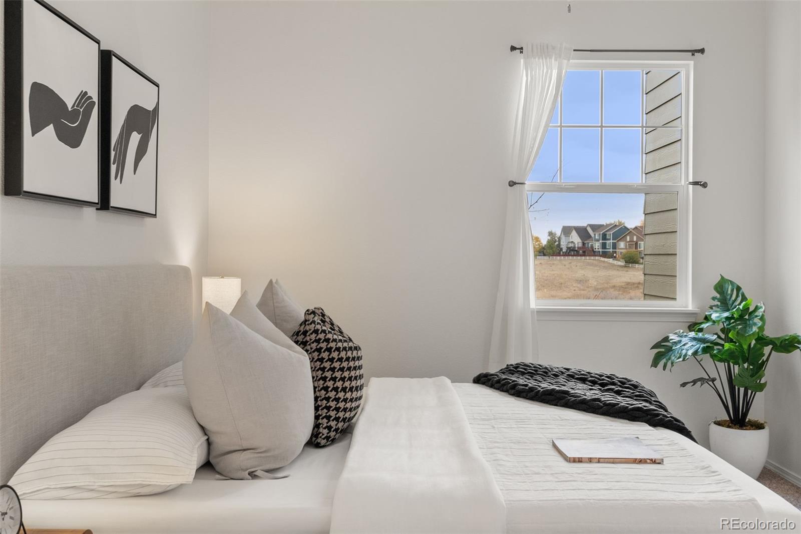 8420 Canyon Rim Trail, Unit 305 Parker, CO 80134 - Photo 13 of 44 a bedroom with a bed and a potted plant
