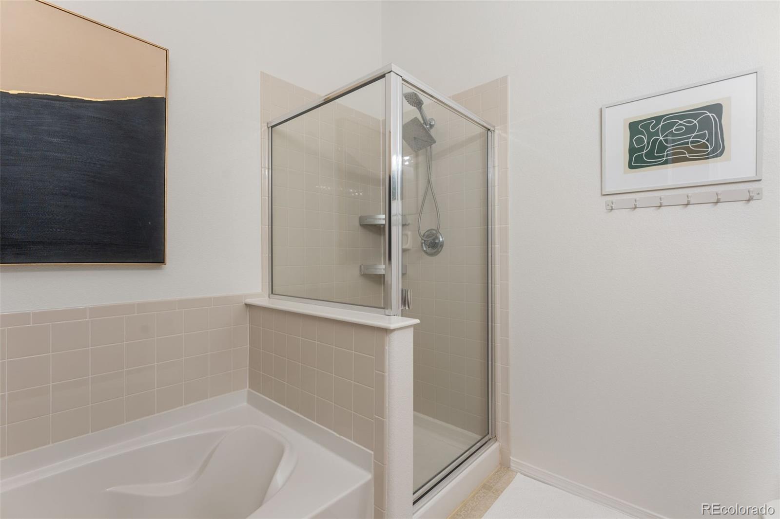 8420 Canyon Rim Trail, Unit 305 Parker, CO 80134 - Photo 18 of 44 a bathroom with a shower and a bath tub