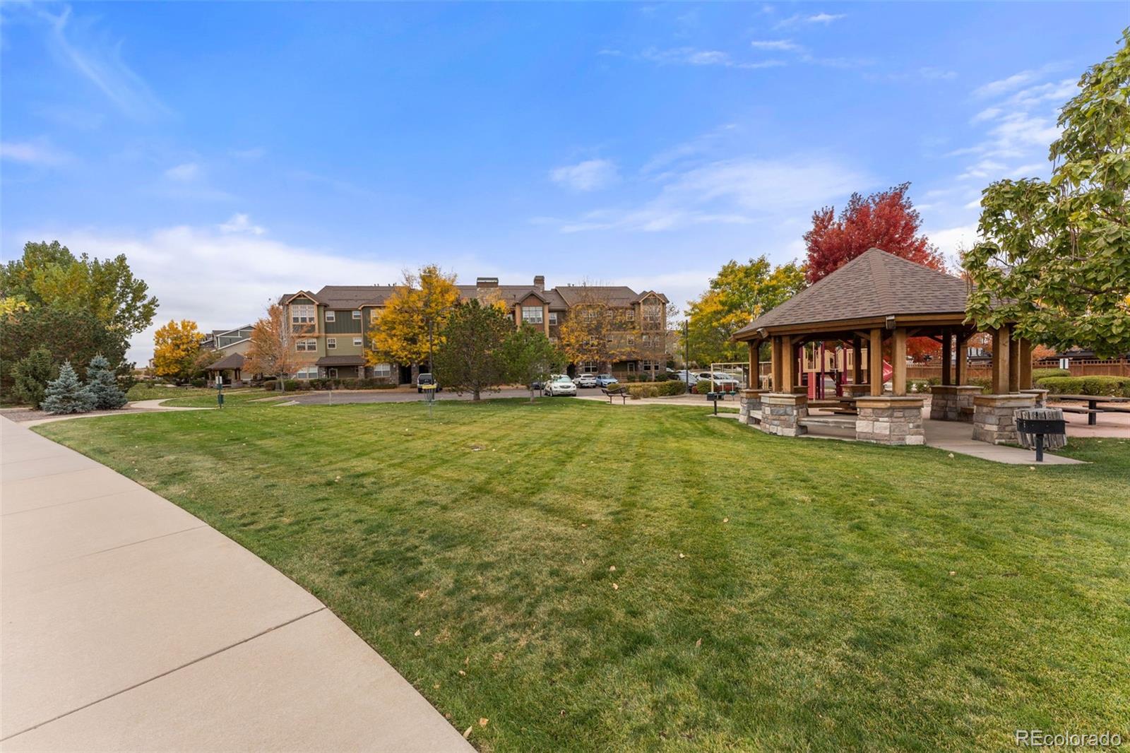 8420 Canyon Rim Trail, Unit 305 Parker, CO 80134 - Photo 27 of 44 a view of a house with a yard