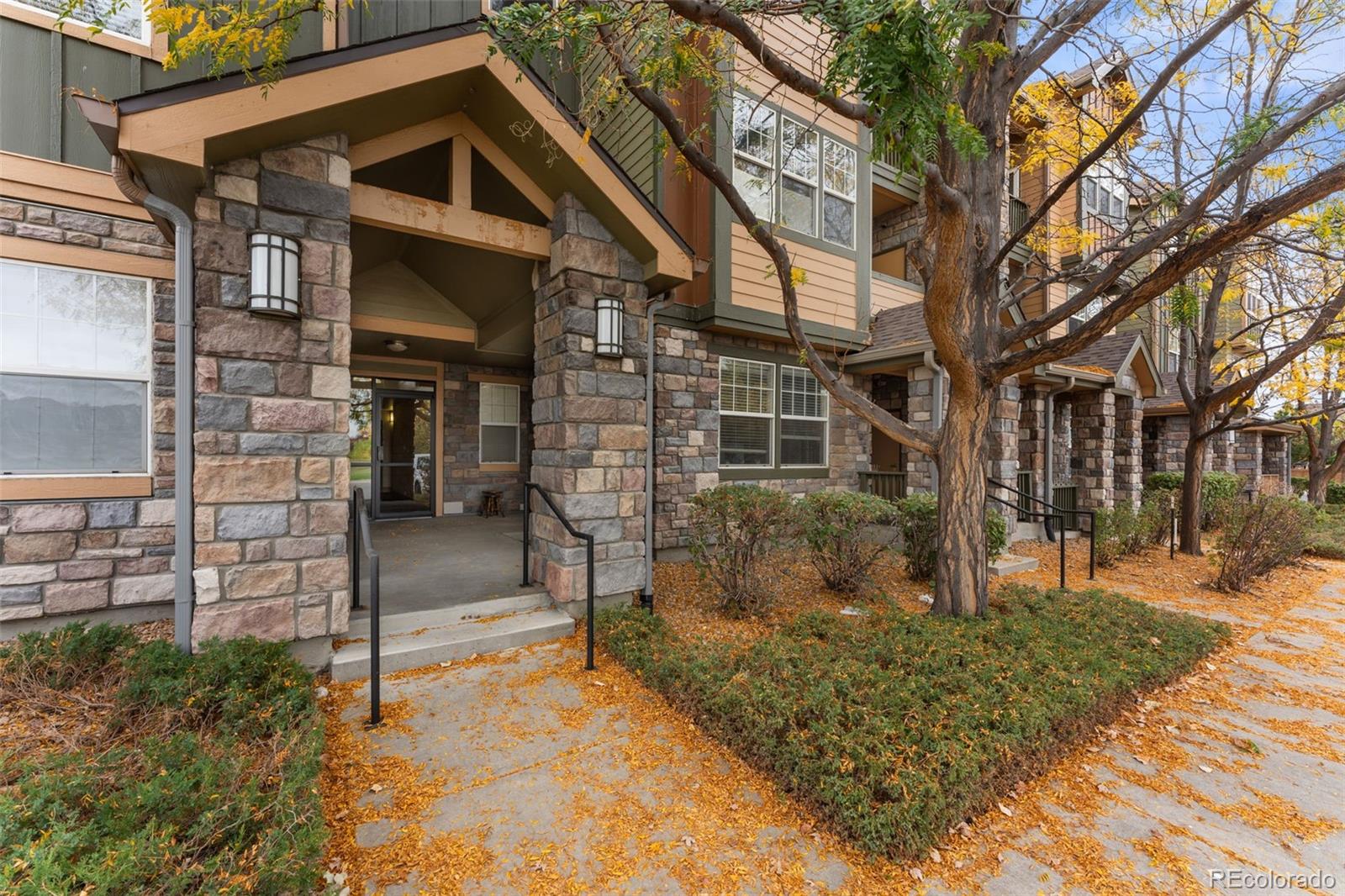 8420 Canyon Rim Trail, Unit 305 Parker, CO 80134 - Photo 3 of 44 a front view of a house with a yard