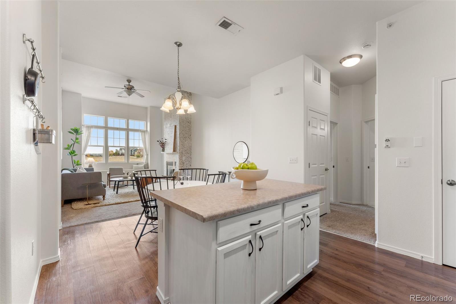 8420 Canyon Rim Trail, Unit 305 Parker, CO 80134 - Photo 33 of 44 a kitchen with a counter space dining table and stainless steel appliances