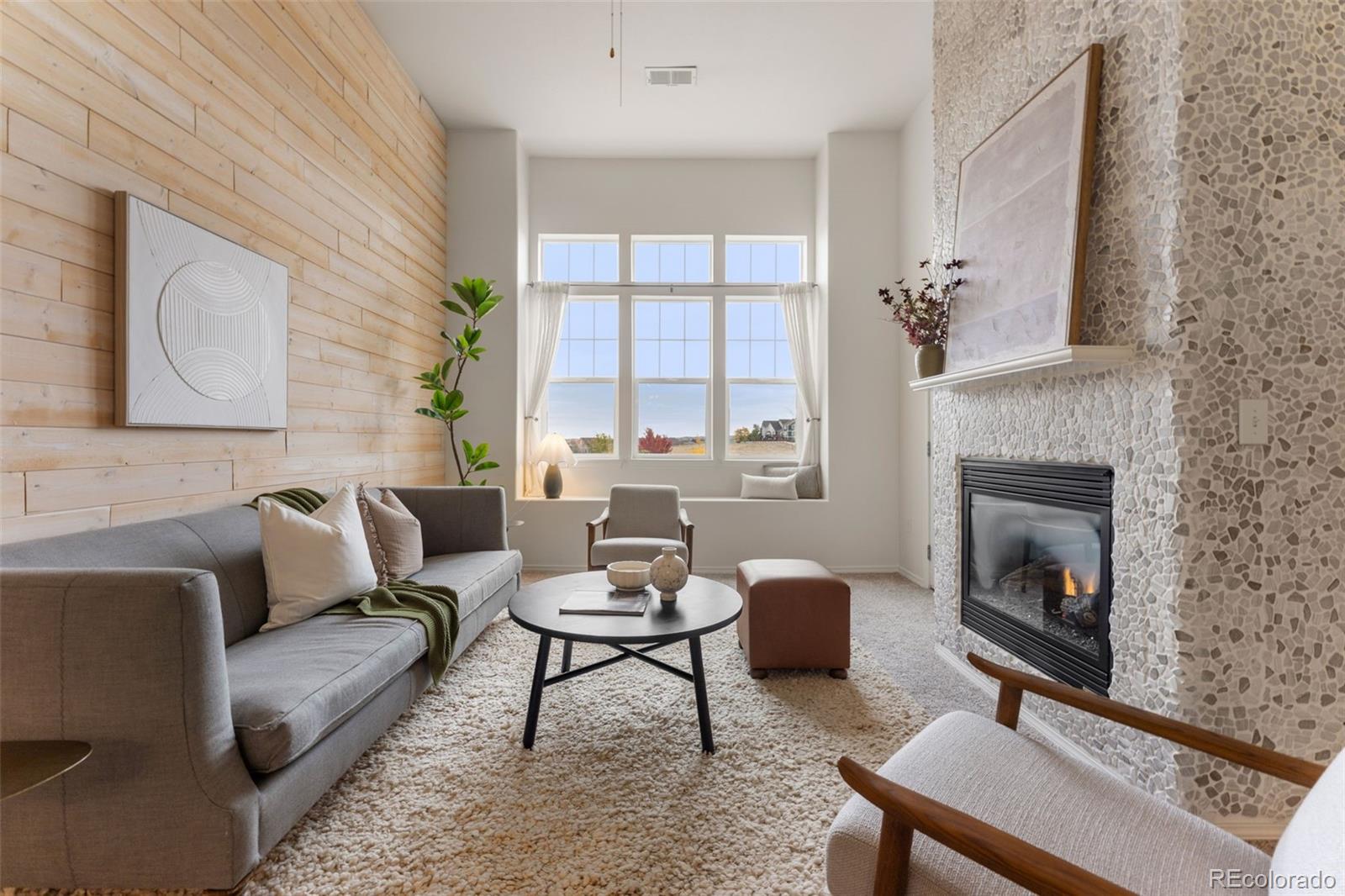 8420 Canyon Rim Trail, Unit 305 Parker, CO 80134 - Photo 34 of 44 a living room with furniture and a fireplace