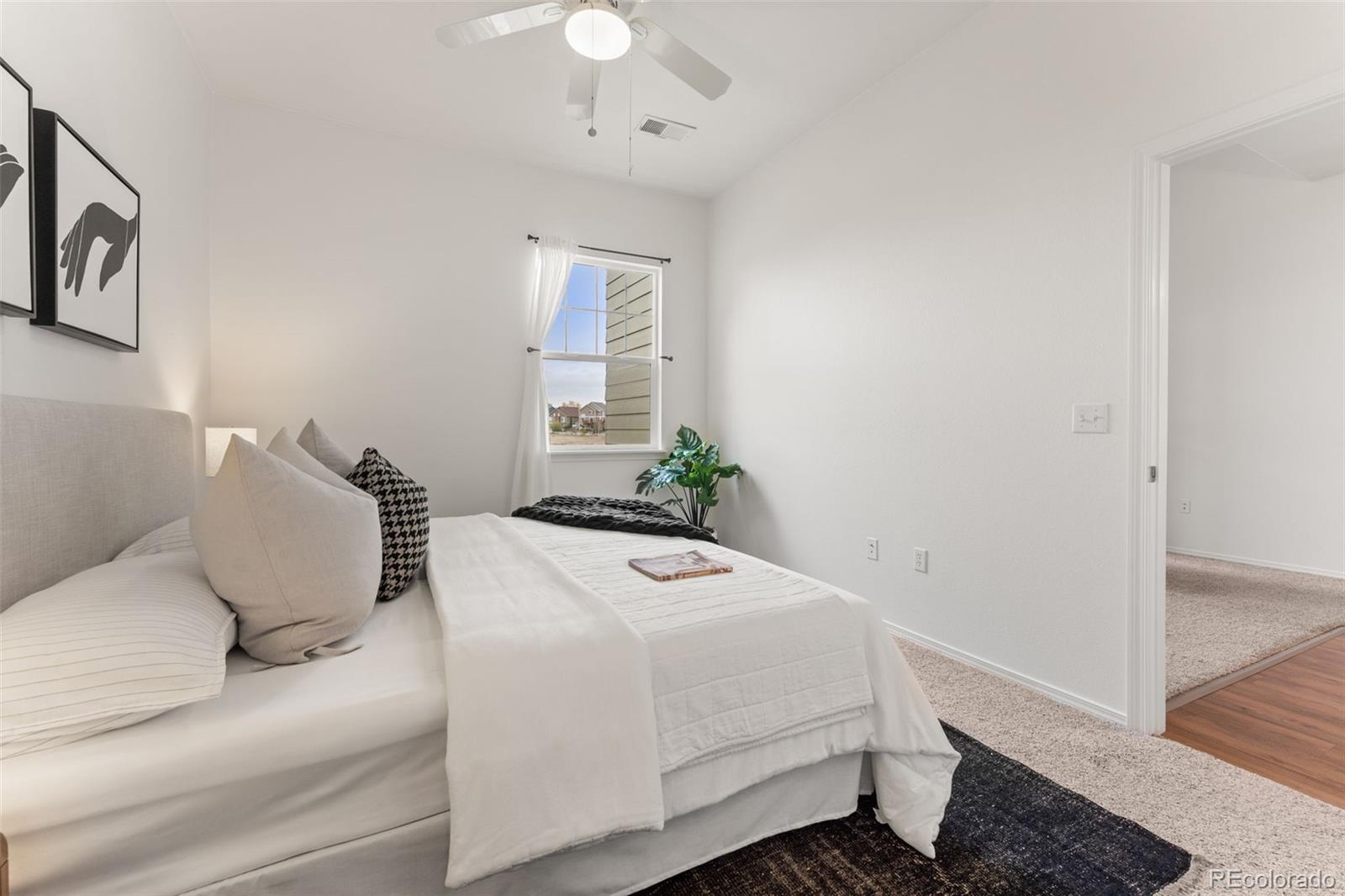 8420 Canyon Rim Trail, Unit 305 Parker, CO 80134 - Photo 39 of 44 a bedroom with a bed and a potted plant