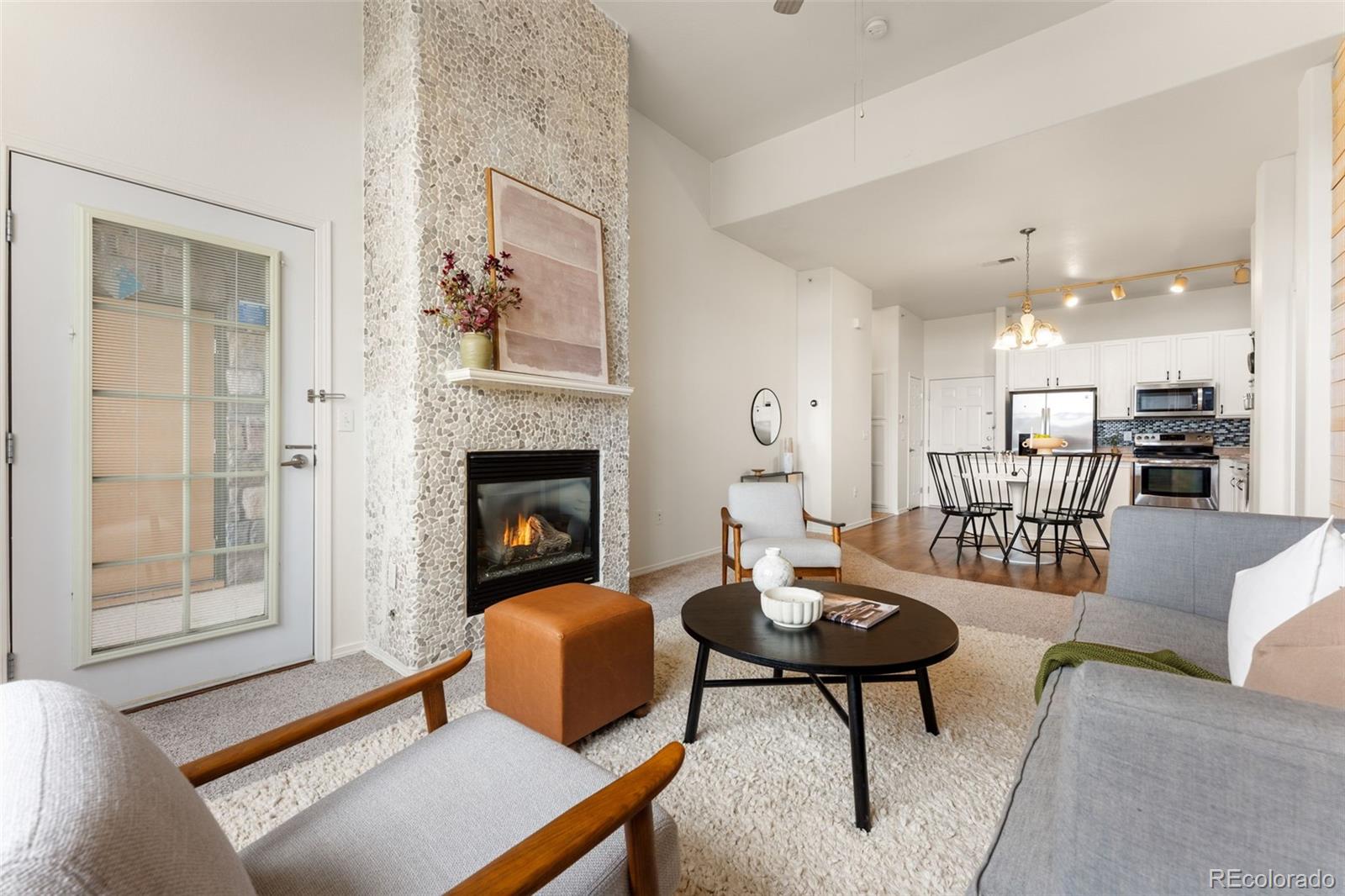 8420 Canyon Rim Trail, Unit 305 Parker, CO 80134 - Photo 5 of 44 a living room with furniture and a fireplace