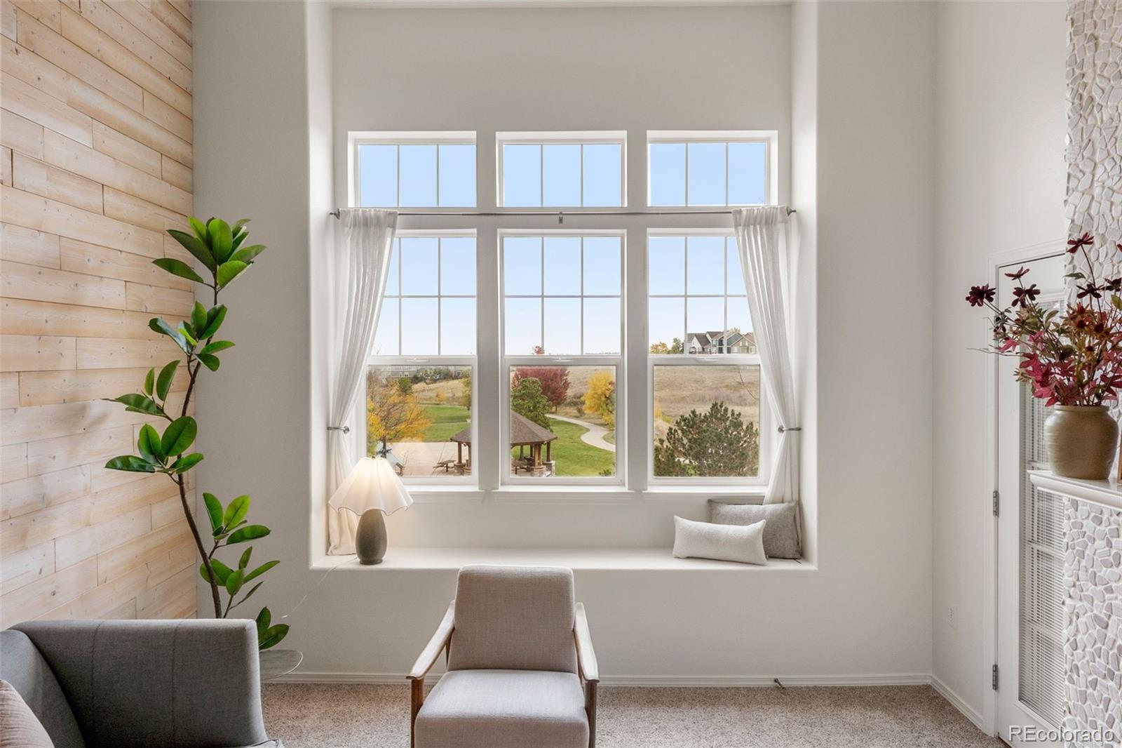 8420 Canyon Rim Trail, Unit 305 Parker, CO 80134 - Photo 6 of 44 a living room with furniture and a potted plant