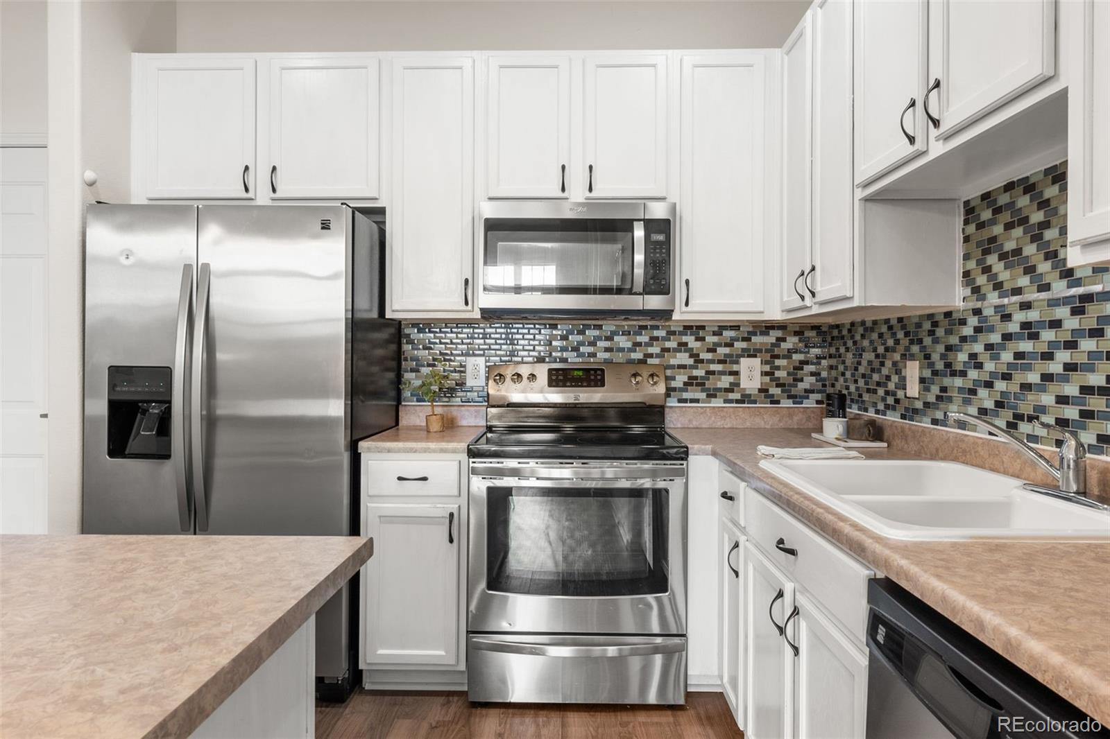 8420 Canyon Rim Trail, Unit 305 Parker, CO 80134 - Photo 10 of 44 a kitchen with a stove and a refrigerator