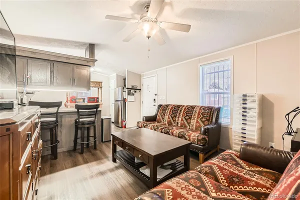 a living room with furniture and a chandelier