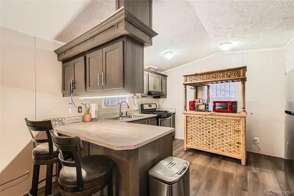 a kitchen with a sink cabinets and wooden floor
