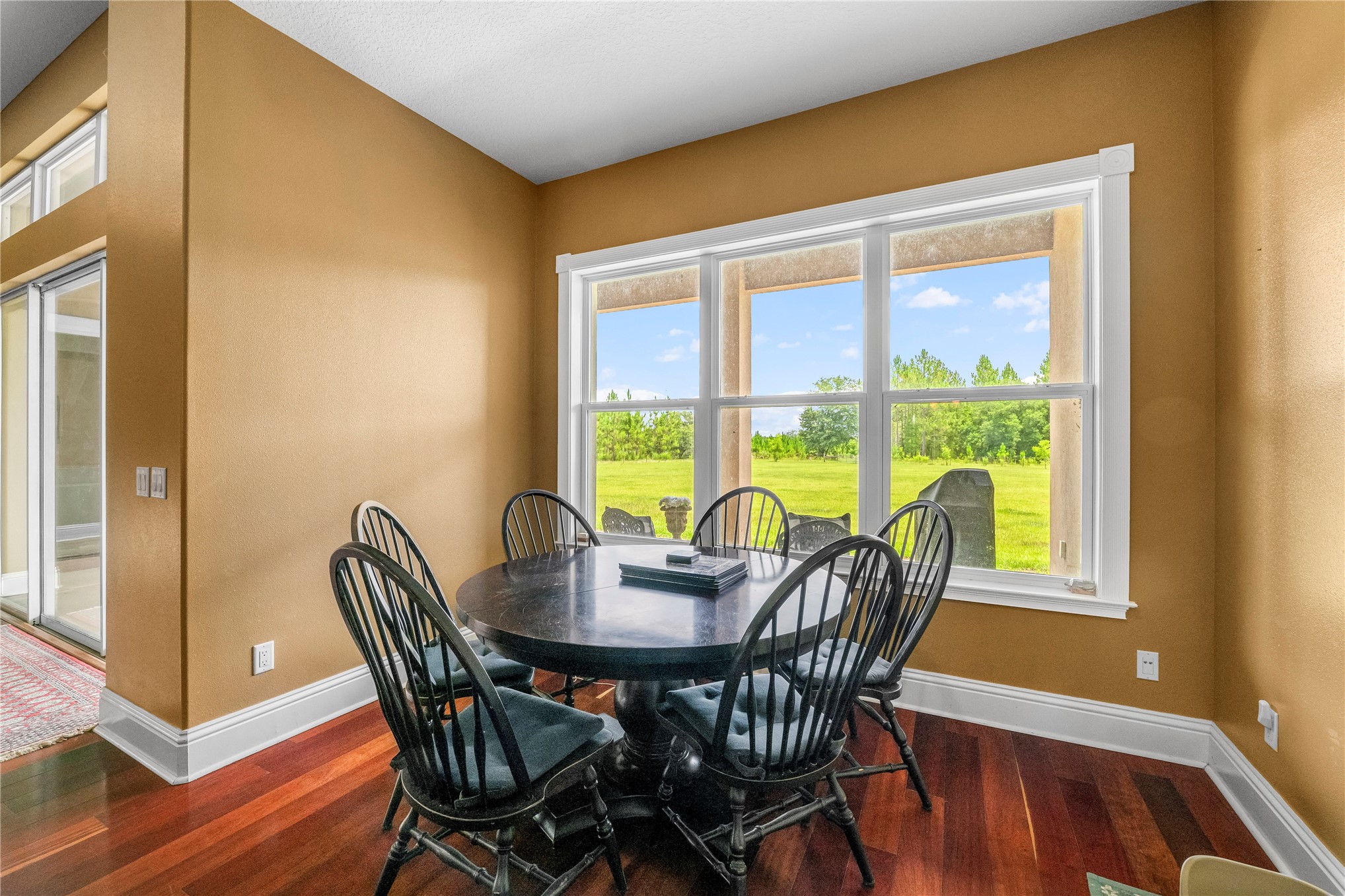 27247 Hallman Road Hilliard, FL 32046 - Photo 22 of 59 a view of a dining room with furniture and wooden floor