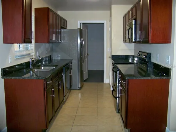 a kitchen with stainless steel appliances granite countertop a stove and a refrigerator