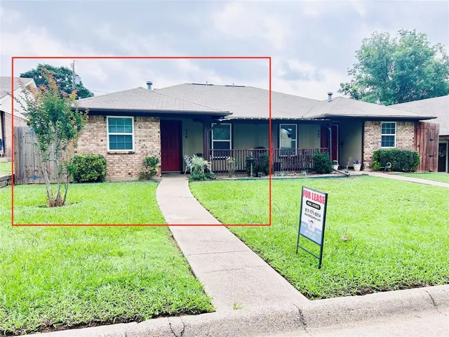 a view of a house with a yard and plants
