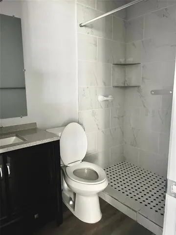 a bathroom with a sink a toilet and a shower