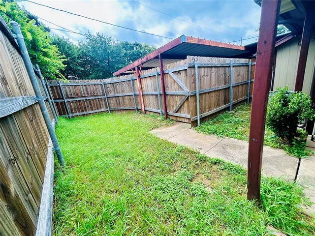 a view of backyard with deck and garden
