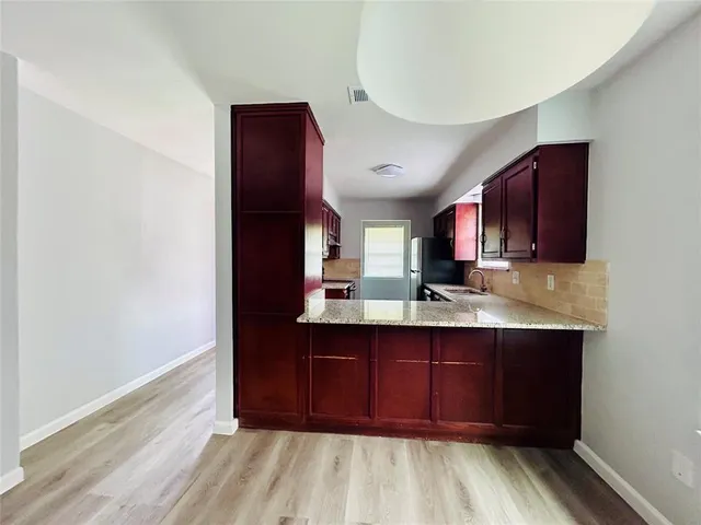 a view of kitchen with wooden floor