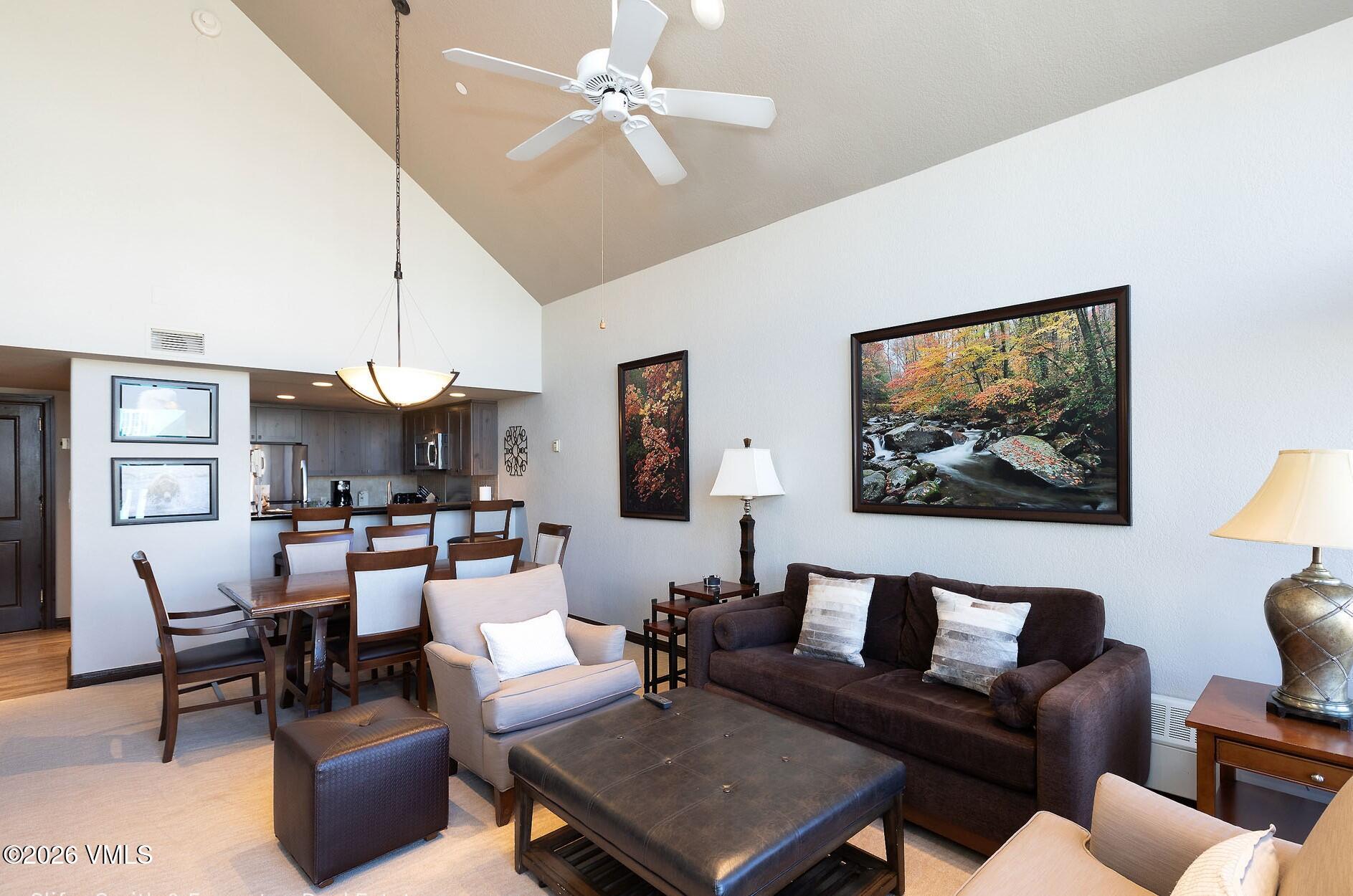 210 Offerson Road, Unit 41249 Beaver Creek, CO 81620 - Photo 3 of 25 a living room with furniture a chandelier and a painting
