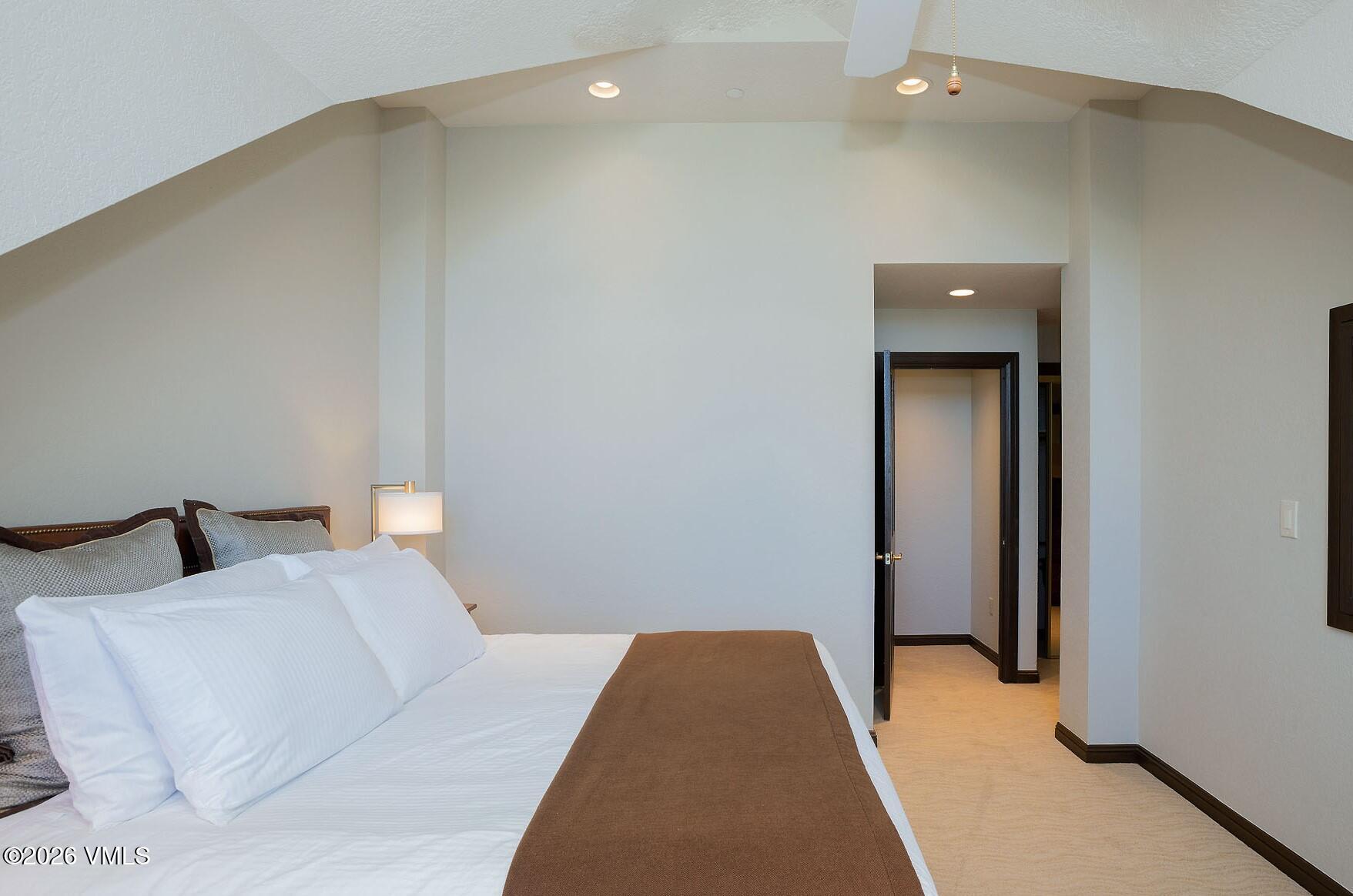 210 Offerson Road, Unit 41249 Beaver Creek, CO 81620 - Photo 8 of 25 a bedroom with a bed and a mirror
