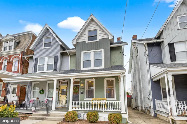 a view of a brick house with large windows