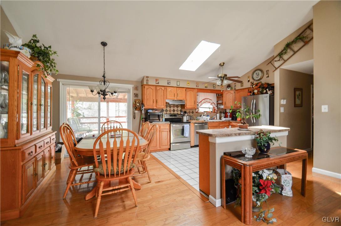 253 Sundance Road Effort, PA 18330 - Photo 7 of 25 a dining room with furniture a chandelier and wooden floor