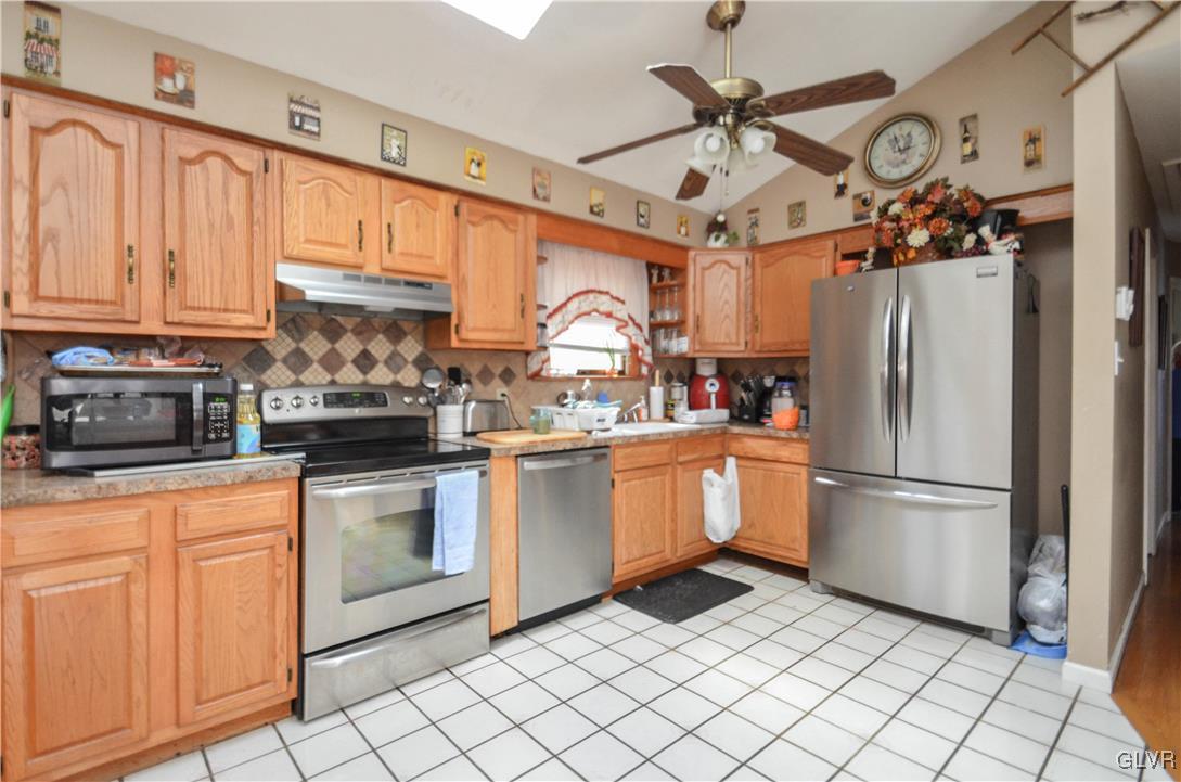 253 Sundance Road Effort, PA 18330 - Photo 9 of 25 a kitchen with cabinets stainless steel appliances and a counter top space