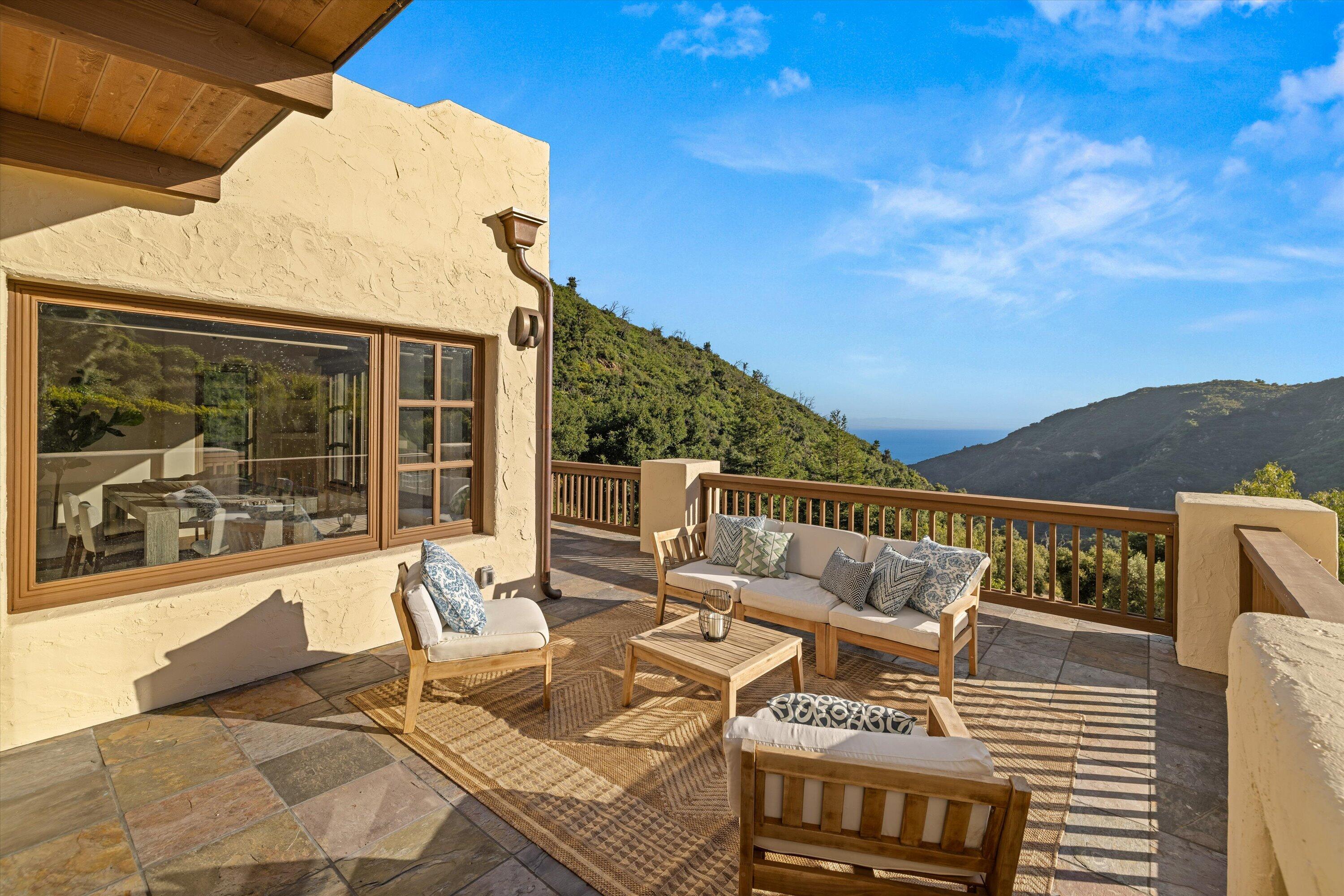 1090 Toro Canyon Road Santa Barbara, CA 93108 - Photo 26 of 59 a view of a patio with couches chairs and wooden floor