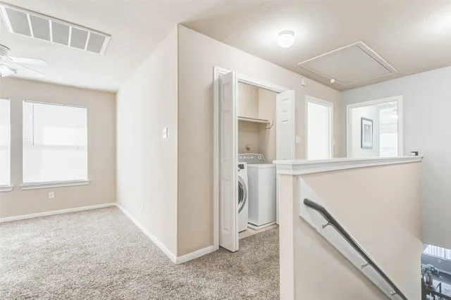 a view of empty room with windows and wardrobe