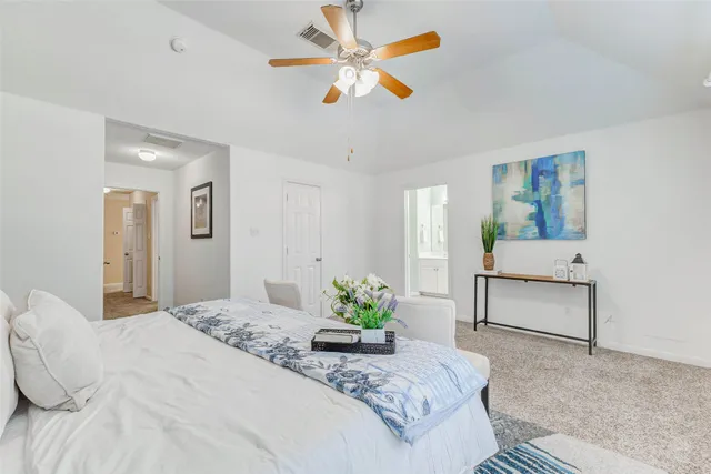 a bedroom with a bed and ceiling fan
