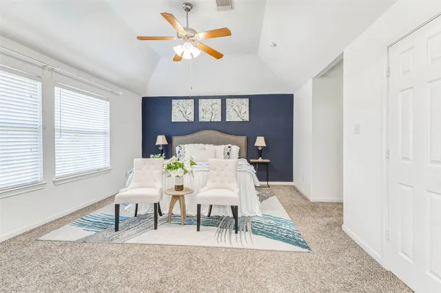 a bedroom with a bed a rug and a window